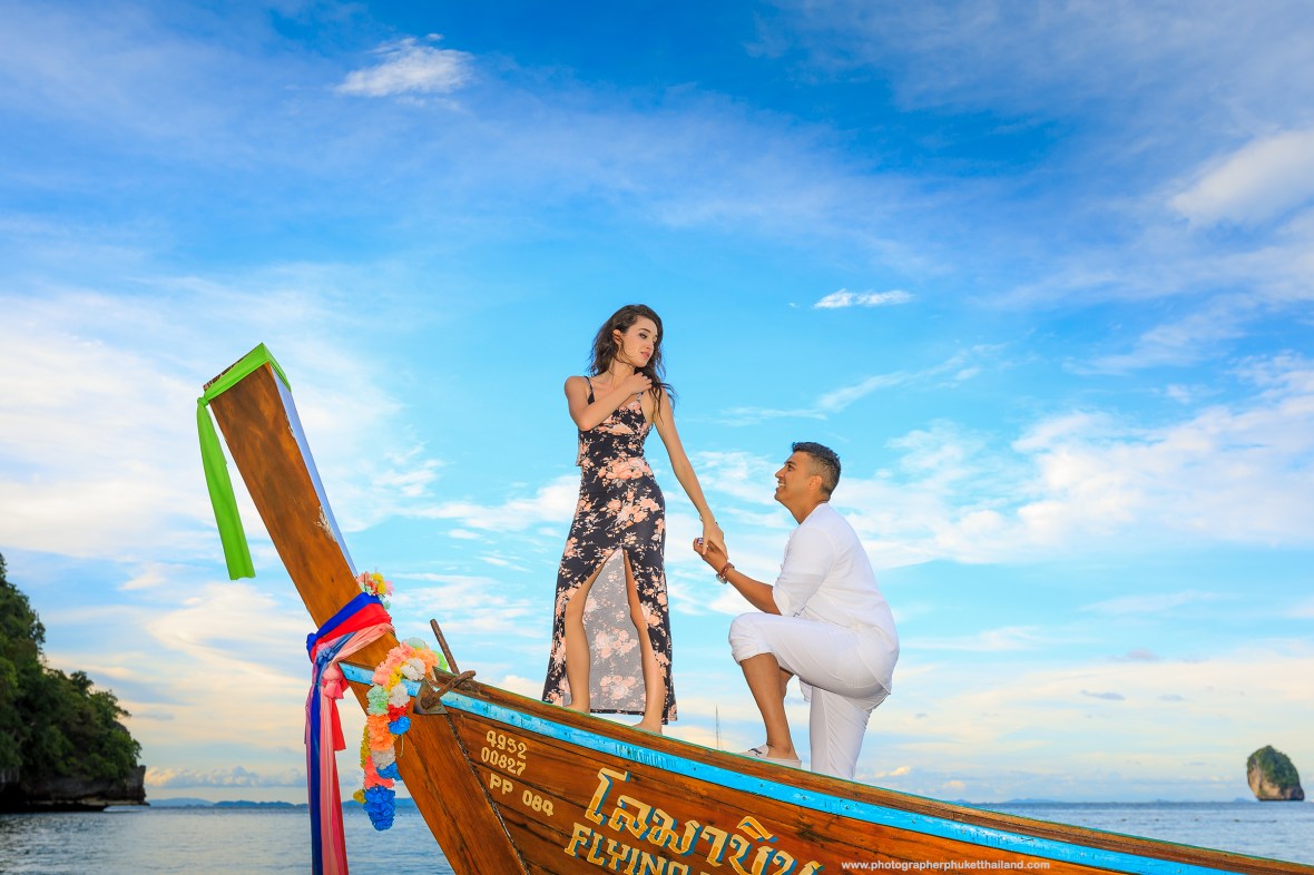 Marriage proposal photoshoot on long tail boat at monkey beach Phi Phi island Krabi Thailand