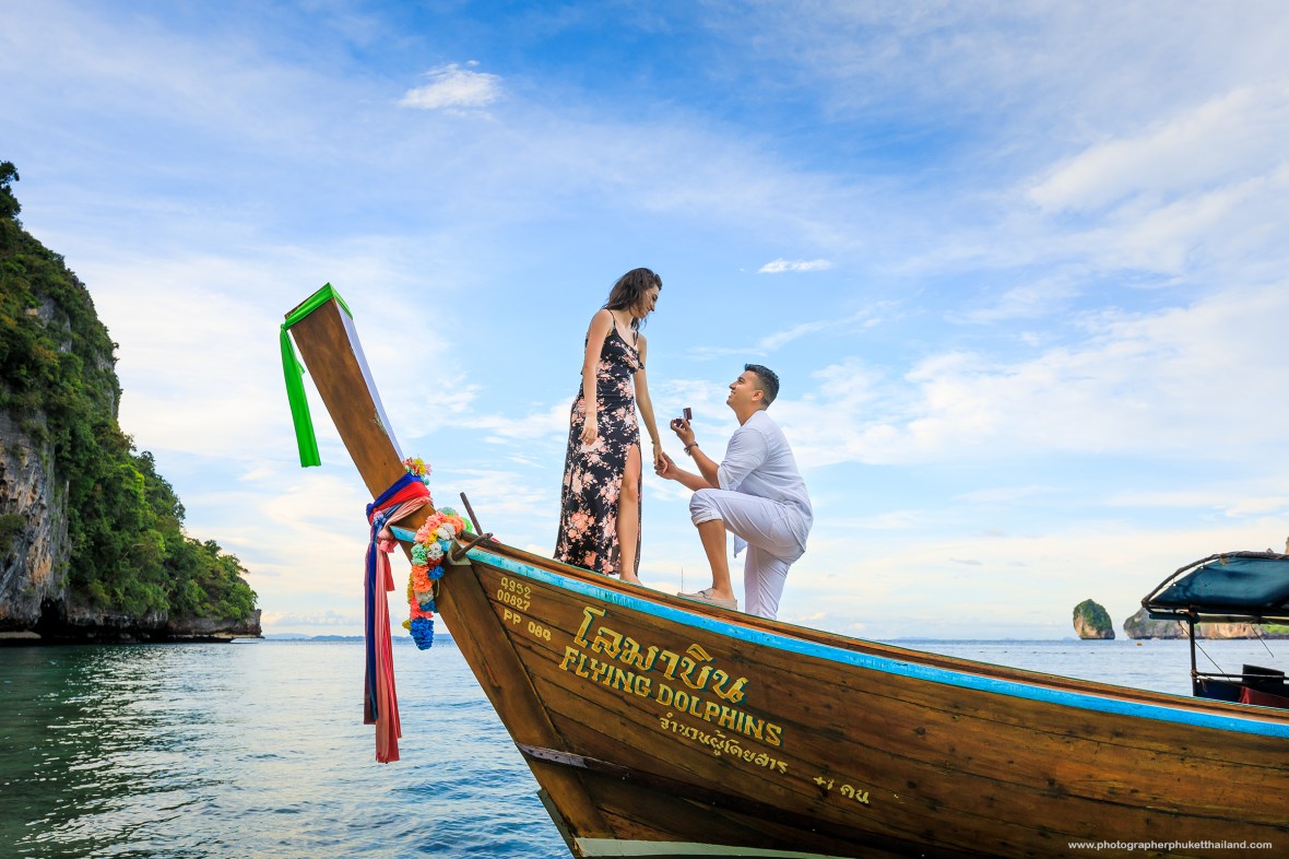 Marriage proposal photoshoot on long tail boat at monkey beach Phi Phi island Krabi Thailand