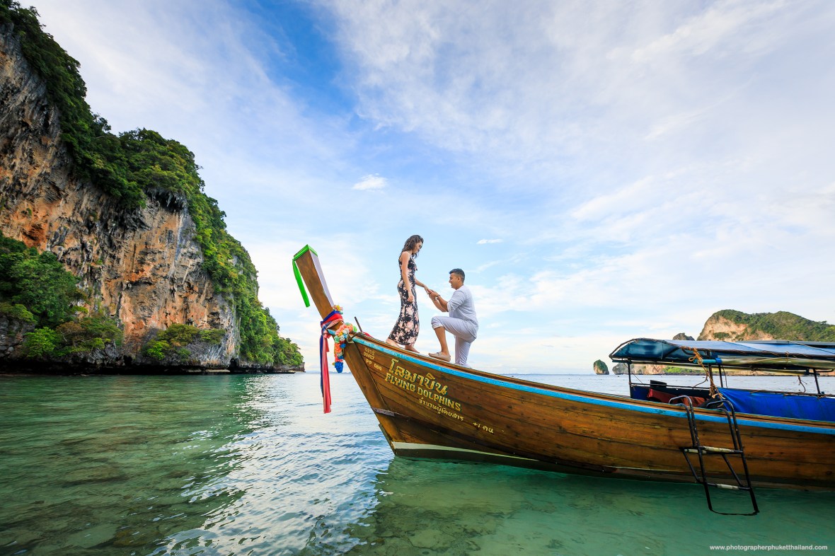 Marriage proposal photoshoot on long tail boat at monkey beach Phi Phi island Krabi Thailand