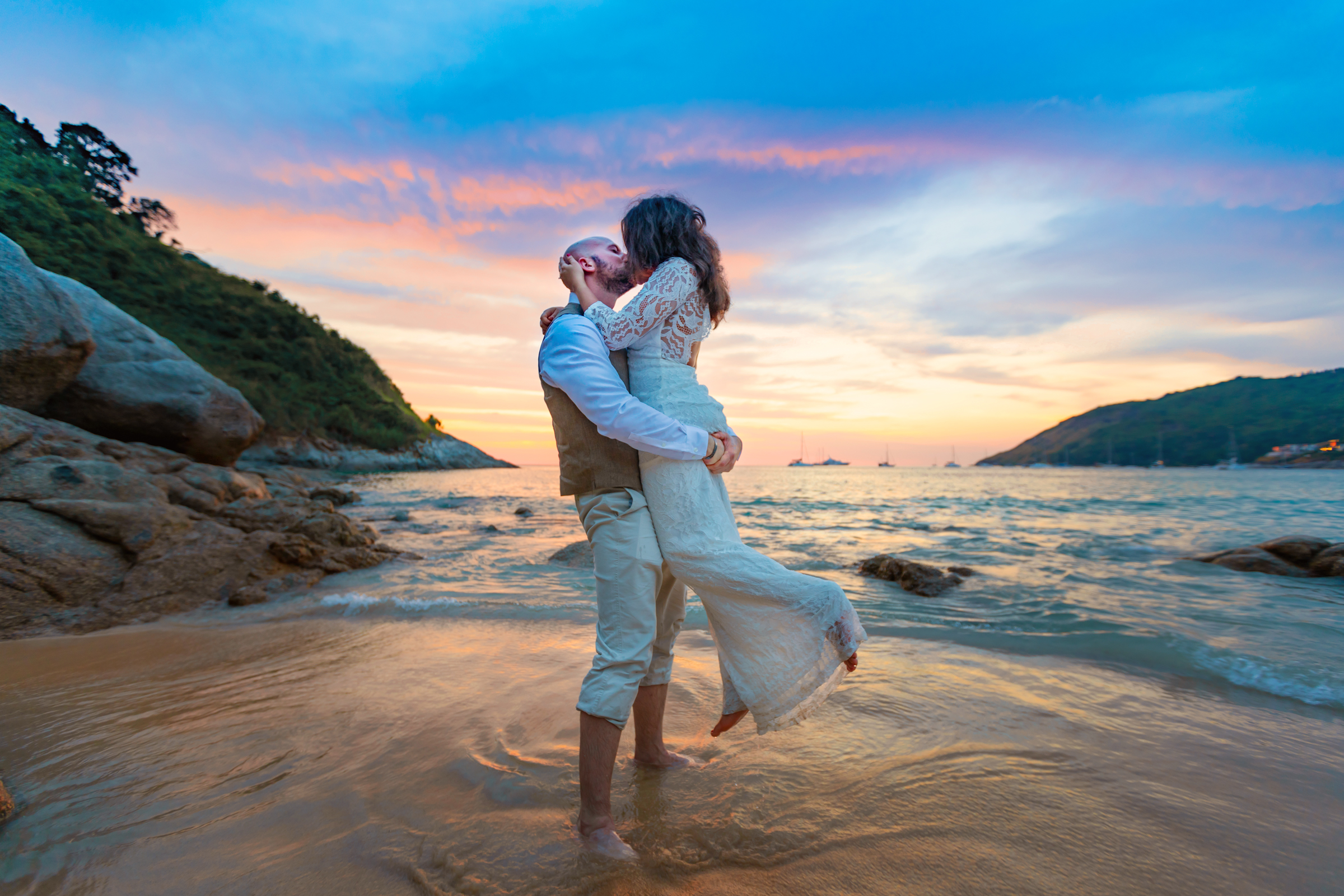 wedding photoshoot as sunset at nai harn beach phuket