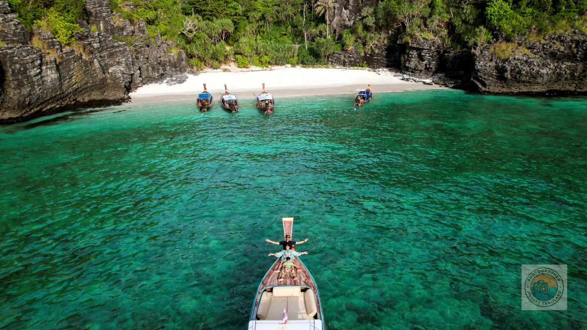 family photography on long tail boat by drone at nui bay phi phi island krabi